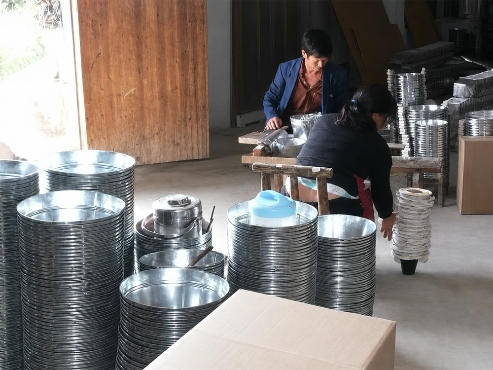 Workers checking and assembling metal products