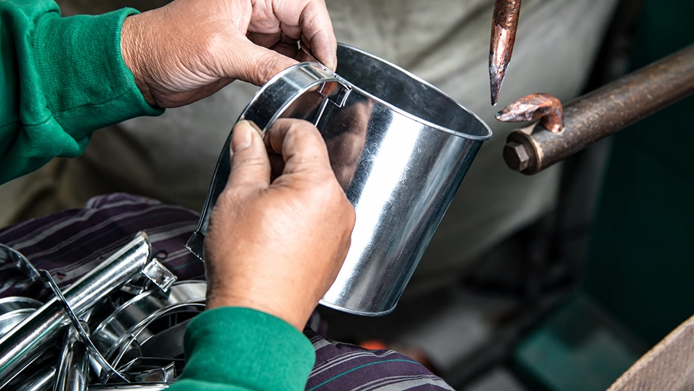 Hand assembly detail on a small metal bucket